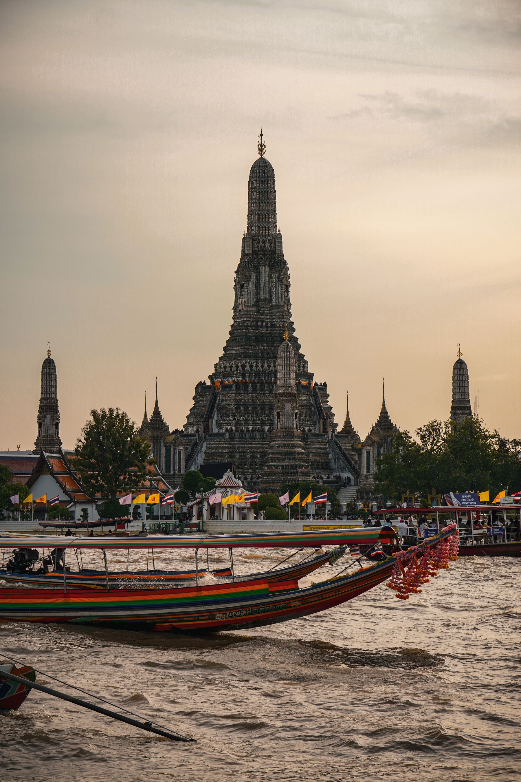 Wat Arun with boats on the Chao Phraya at sunset