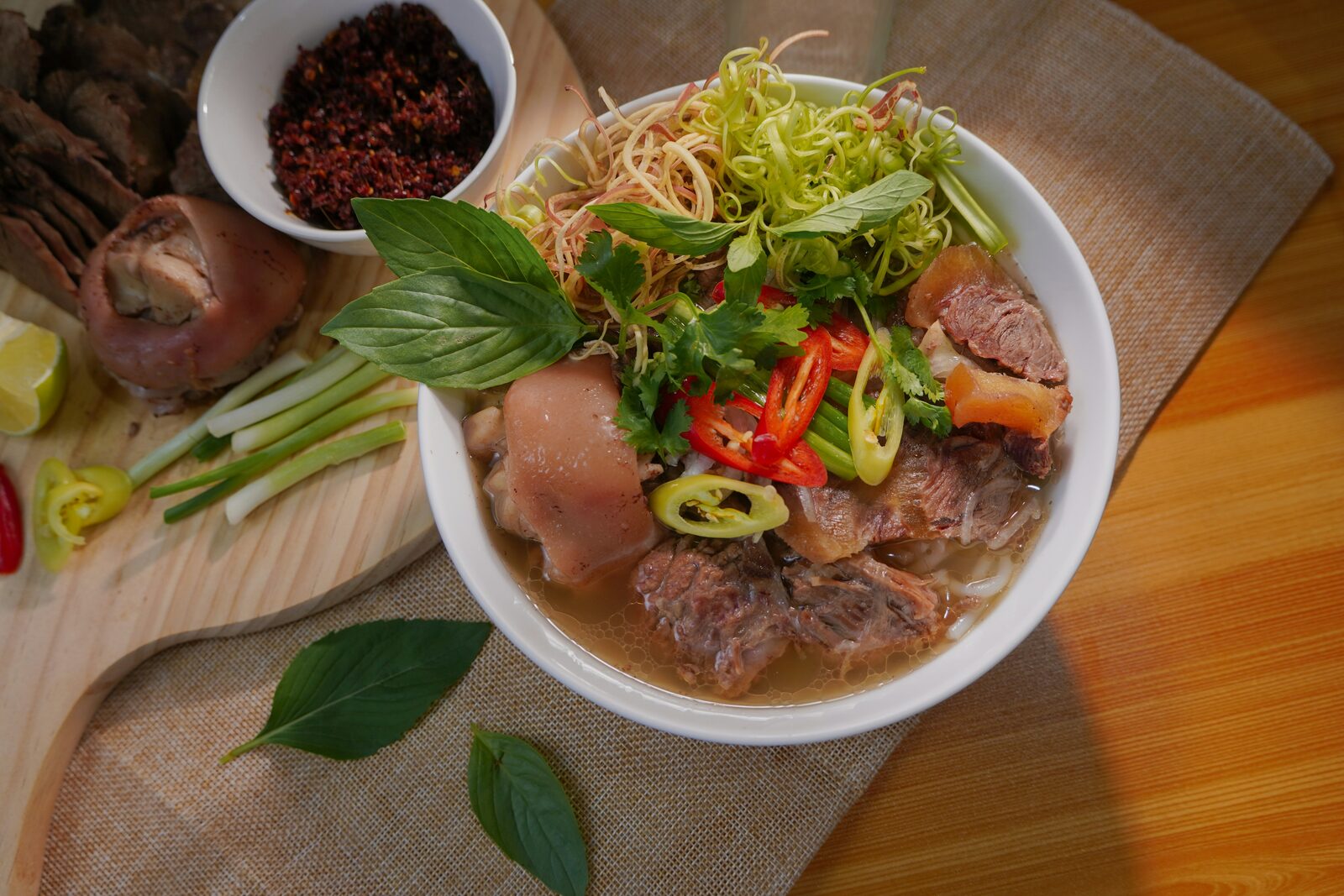 A bowl of Vietnamese pho with fresh herbs